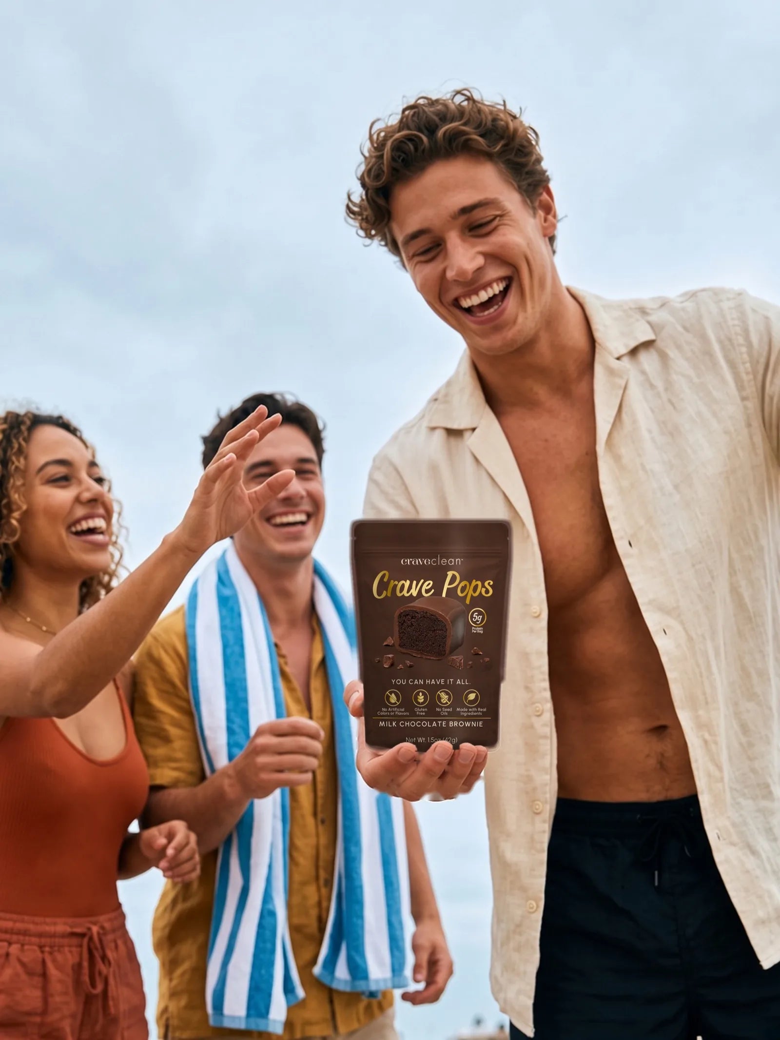 Friends sharing Milk Chocolate Brownie Crave Pops at the beach